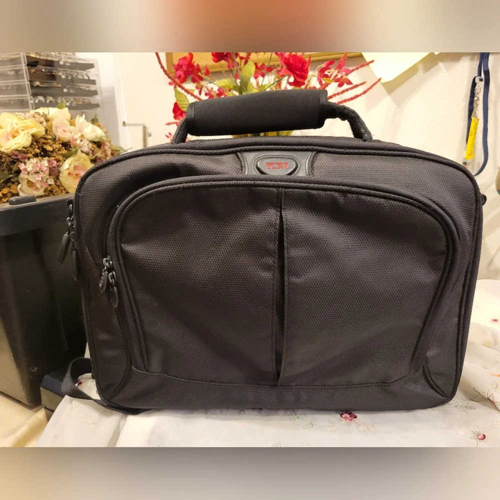 TUMI Black Backpack with Padded Straps and Multiple Compartments